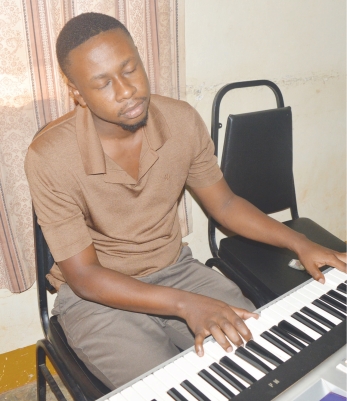 Watuulo plays the piano, right, the drums